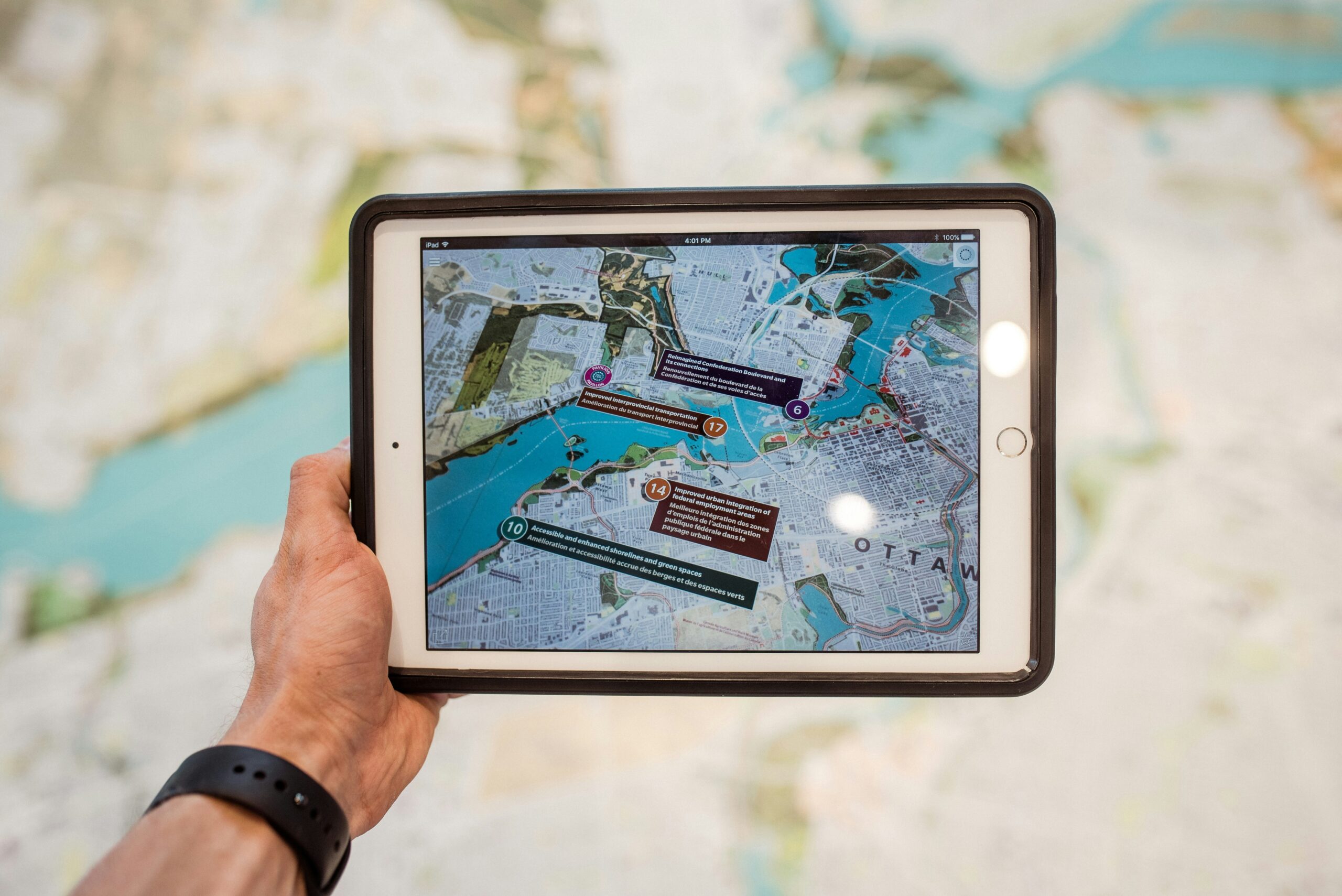 person holding white ipad with black case